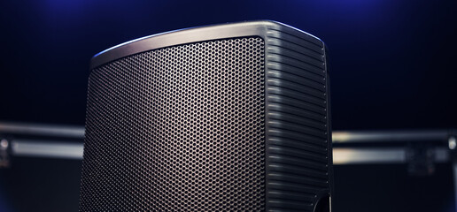Close-up of a sound speaker against the background of concert lighting