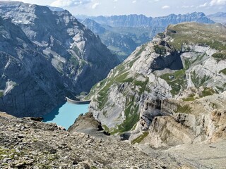 Kistenpass hut. View of the Limmernsee dam in the canton of Glarus. Hiking high above the mountain...
