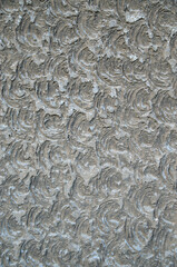 Old gray relief cement plaster on wall close
