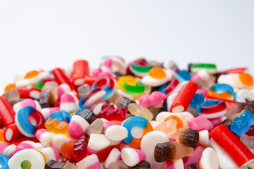 Tasty mix of jelly colorful candies isolated on a white background.