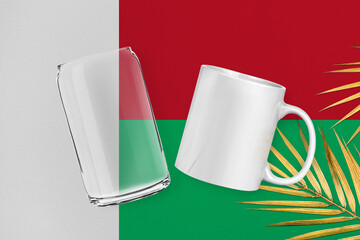 Patriotic can glass and mug mock up on background in colors of national flag. Madagascar
