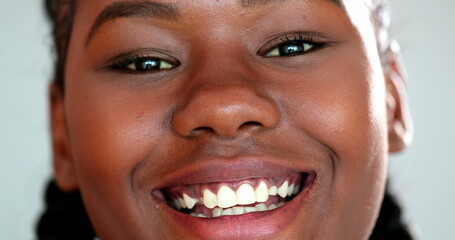 Happy young black woman smiling. Extreme close-up face of African girl in 20s