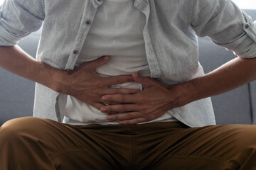 man having a stomach ache. Problems and health care concepts
