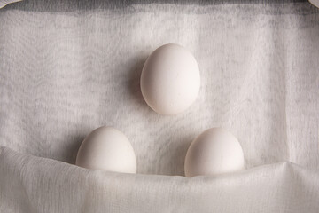 Chicken white eggs on burlap. Farm products. Natural eggs. Chicken eggs on the table.