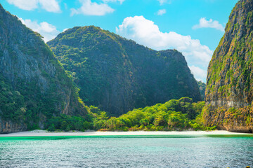 Panorama of Phi Phi famous island in Thailand with sea, boats and mountains in beautiful lagoon where the Beach movie was filmed
