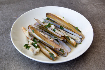 Plate with cooked razor shells in french Brittany