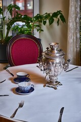 Photo of a samovar standing on a table 