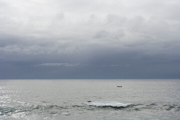 Fototapeta na wymiar Lonely small fishing boat in the sea
