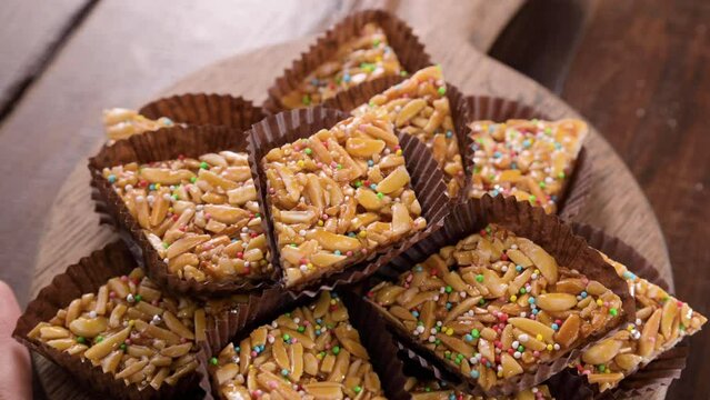 Desserts with almonds, peanuts and seeds in caramel. Traditional Sardinian sweet. Sweet squares. High quality 4k footage. Almond Gateau, sarda Food, Italian Dessert