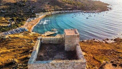 Aerial shot of Lippija tower on a shore of sea at sunset