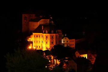 Fototapeta na wymiar Bečov State Castle illuminated by lights at night in the dark
