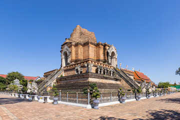 Fototapeta premium Wat Chedi Luang Varavihara surrounding with color flag, a destination of tourist in Chiang Mai, Northern of Thailand