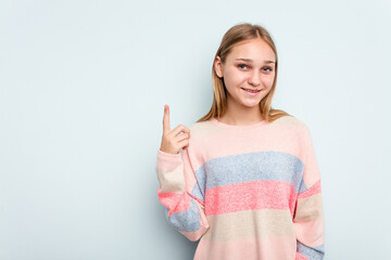 Young caucasian girl isolated on blue background showing number one with finger.