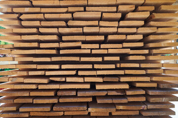 Sustainable wooden planks stacked ready for transport