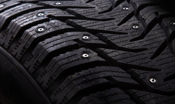 Winter studded car tire with snow spikes