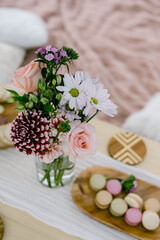 flowers and macarons on a picnic setting