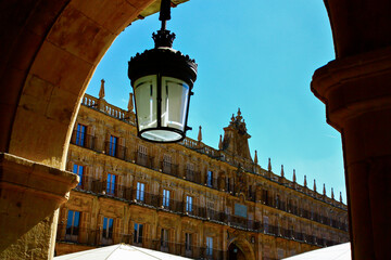 Traditional lantern in an arch of the main square of Salamanca, Spain, in a sunny summer day with a bright blue sky
