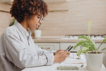 The homeowner calculates the new prices in the kitchen.