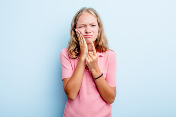 Caucasian teen girl isolated on blue background having a strong teeth pain, molar ache.