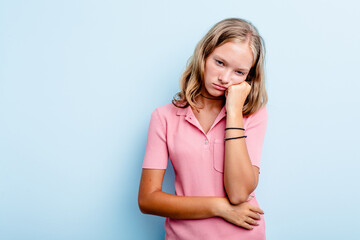Caucasian teen girl isolated on blue background who feels sad and pensive, looking at copy space.