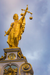 Historic Justice Palace golden statue with balance, Bruges, Belgium