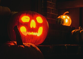 Jack-o-lanterns on a doorstep on a Halloween night