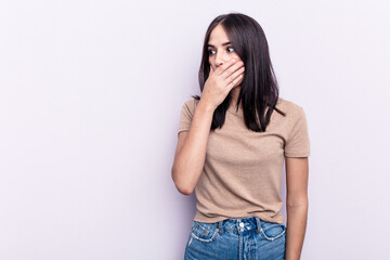 Young caucasian woman isolated on pink background thoughtful looking to a copy space covering mouth with hand.