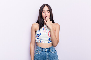 Young caucasian woman isolated on pink background yawning showing a tired gesture covering mouth with hand.