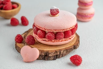 Zelfklevend Fotobehang Closeup of a pink raspberry macaron © Bite Size01/Wirestock Creators