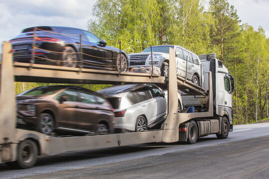 Car transporter transports cars on road