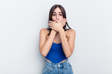 Young caucasian woman isolated on white background covering mouth with hands looking worried.