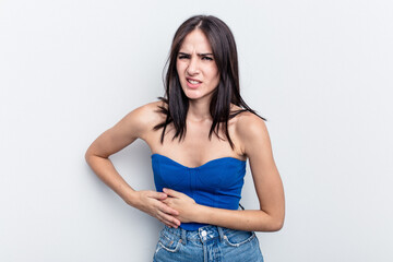 Young caucasian woman isolated on white background having a liver pain, stomach ache.