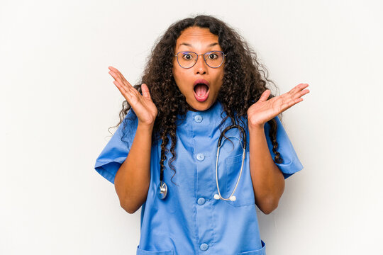 Young hispanic nurse woman isolated on white background surprised and shocked.