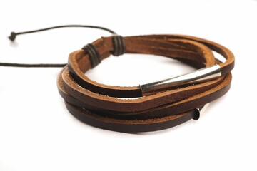 Brown leather bracelet with metallic details on a white background