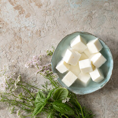 bowl with cubes of feta cheese on a light table - obrazy, fototapety, plakaty