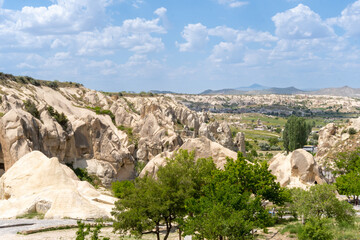 Landscape of Goreme, in Cappadocia, with the typical rocks there on a sunny day with some clouds.