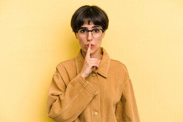 Young caucasian woman with a short hair cut isolated keeping a secret or asking for silence.