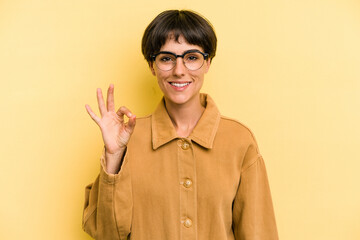 Young caucasian woman with a short hair cut isolated cheerful and confident showing ok gesture.