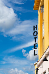 Hotel Lettering from a Yellow Building.
Yellow and white building with a hotel written on the sides...