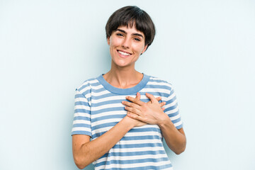 Young caucasian woman with a short hair cut isolated has friendly expression, pressing palm to...