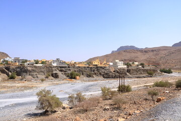 Abandoned village ruins of Riwaygh as-Safil with an oasis underneath on the road between Al Hambra and Jebel Shams, Sultanate of Oman