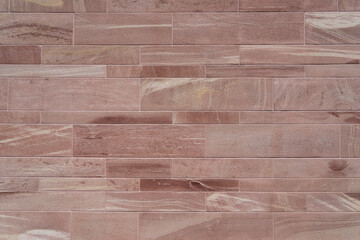 Sandstone background, close-up of beautifully textured red sandstone wall. Copy space for your...