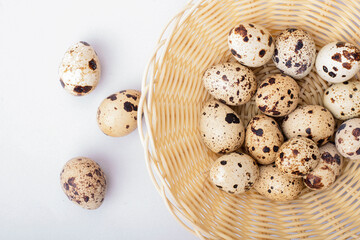 quail eggs in a white wicker basket