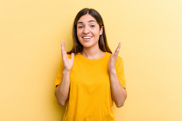 Young caucasian woman isolated on yellow background laughs out loudly keeping hand on chest.