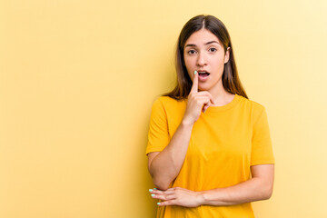 Young caucasian woman isolated on yellow background looking sideways with doubtful and skeptical expression.