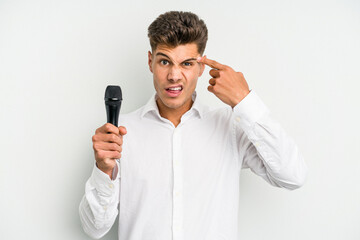Young singer caucasian man isolated on white background showing a disappointment gesture with...