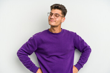 Young caucasian man isolated on white background dreaming of achieving goals and purposes