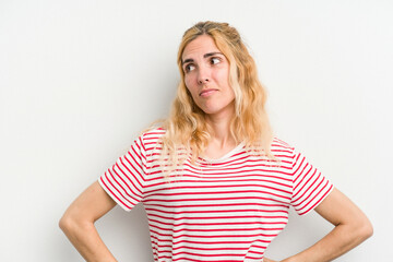 Young caucasian woman isolated on white background dreaming of achieving goals and purposes
