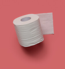 Roll of toilet paper on a pink background.