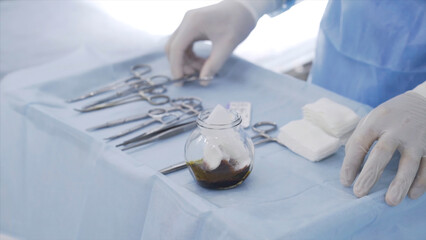 Close-up of surgeon preparing instruments for surgery. Action. Professional surgeon prepared...